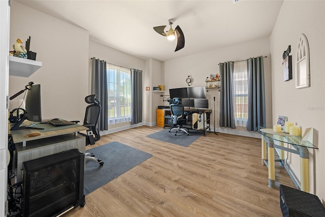 home office featuring ceiling fan and light hardwood / wood-style flooring