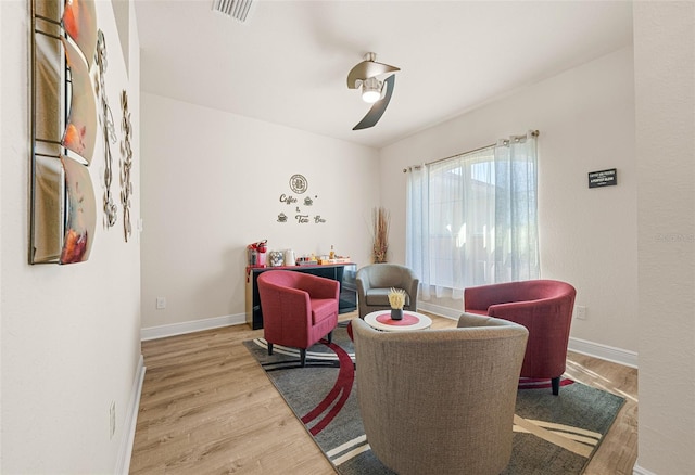 living room with ceiling fan and hardwood / wood-style floors