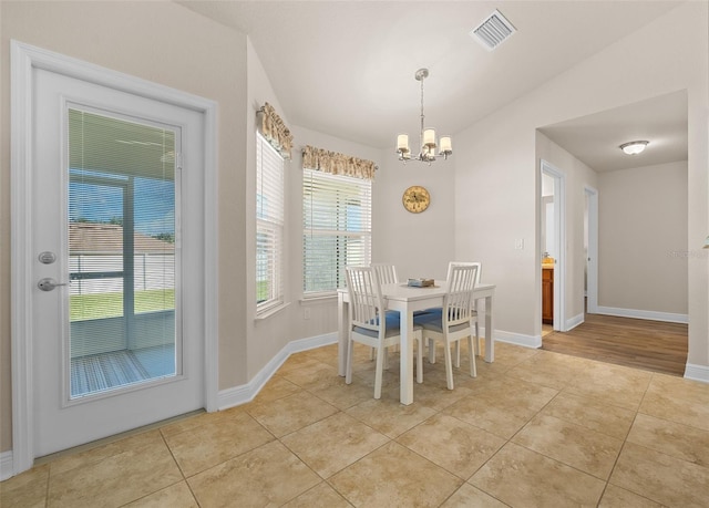 tiled dining space with a notable chandelier