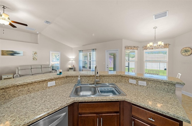 kitchen with ceiling fan with notable chandelier, sink, lofted ceiling, and a wealth of natural light