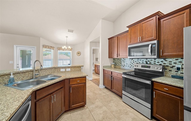 kitchen with backsplash, pendant lighting, stainless steel appliances, sink, and a chandelier