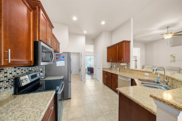 kitchen featuring sink, decorative backsplash, stainless steel appliances, light tile patterned floors, and ceiling fan