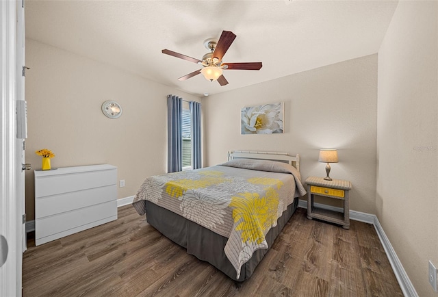 bedroom with ceiling fan and dark wood-type flooring