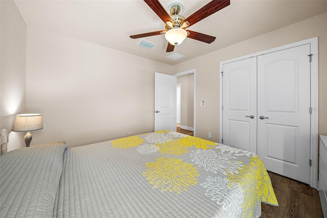 bedroom featuring ceiling fan, a closet, and dark wood-type flooring