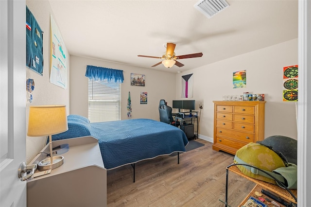 bedroom with hardwood / wood-style floors and ceiling fan