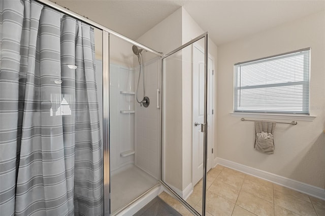 bathroom with a shower with curtain and tile patterned floors