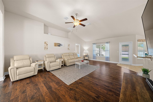 living room featuring vaulted ceiling, ceiling fan, and dark wood-type flooring