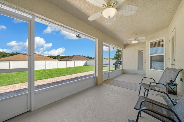 sunroom / solarium featuring ceiling fan