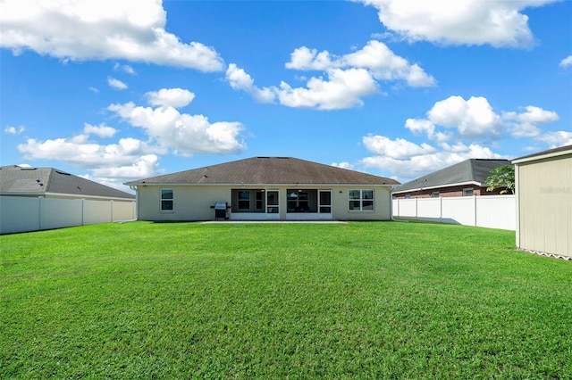 back of property featuring a lawn and a patio area