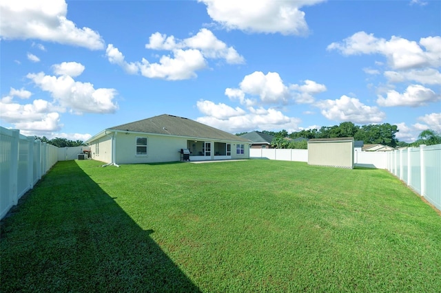 view of yard featuring a storage shed and a patio area