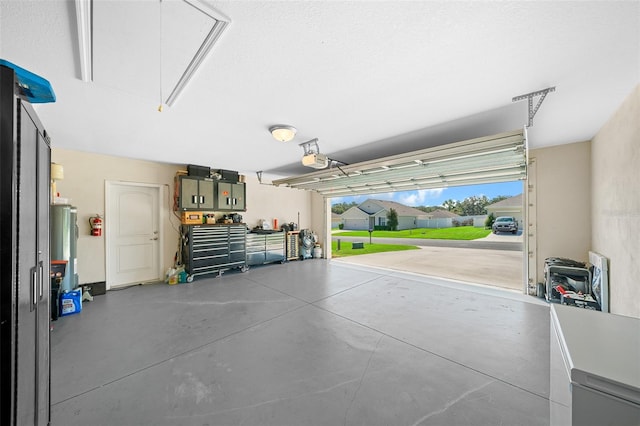 garage featuring gas water heater and a garage door opener