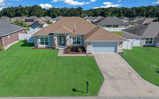 view of front of house with a front yard and a garage