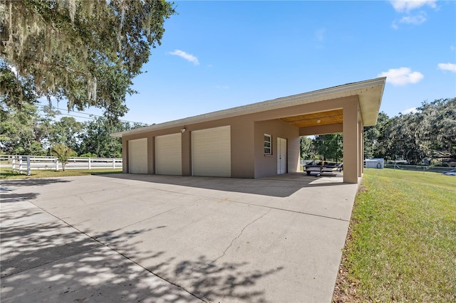 garage featuring a lawn