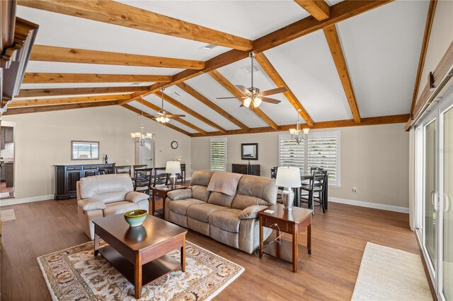 living room with beamed ceiling, ceiling fan with notable chandelier, light hardwood / wood-style floors, and high vaulted ceiling