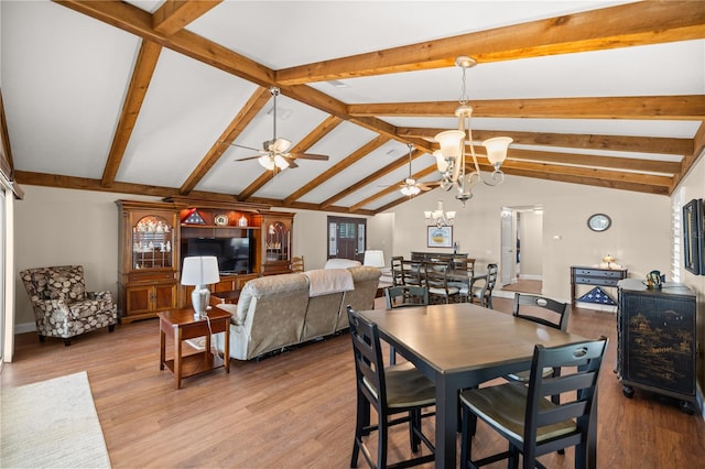 dining area with vaulted ceiling with beams, ceiling fan with notable chandelier, and light hardwood / wood-style floors