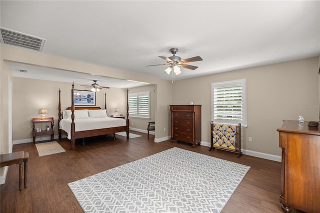 bedroom featuring ceiling fan, dark hardwood / wood-style flooring, and multiple windows