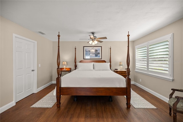 bedroom with dark hardwood / wood-style flooring and ceiling fan