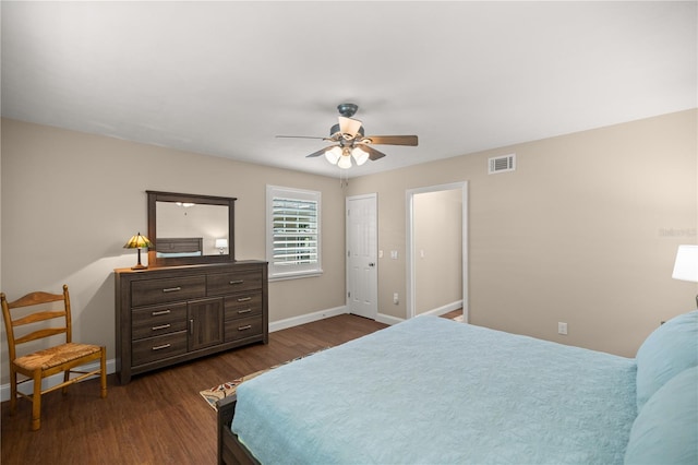 bedroom with dark wood-type flooring, ceiling fan, and a closet