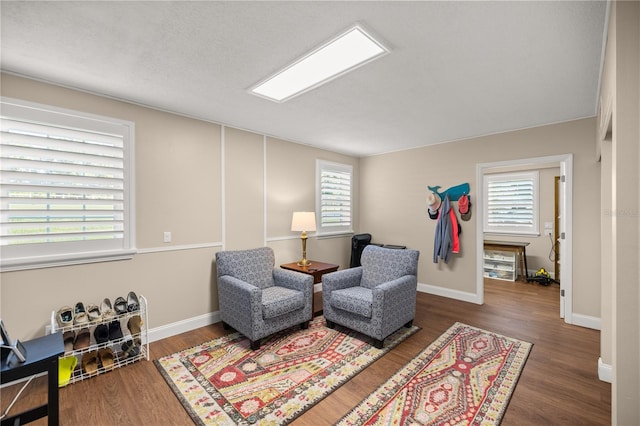 living area featuring plenty of natural light and dark wood-type flooring