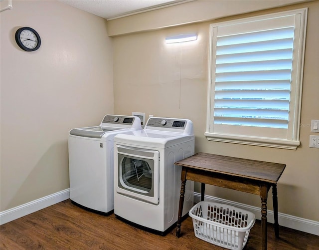 clothes washing area with a textured ceiling, washing machine and dryer, and dark hardwood / wood-style flooring