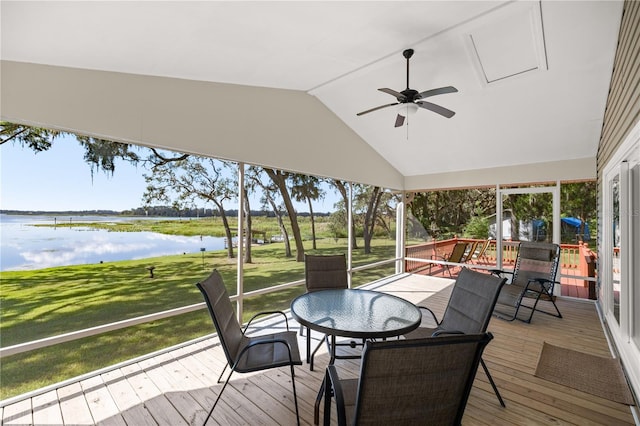 wooden deck featuring a lawn, a water view, and ceiling fan