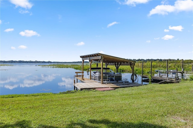 view of dock featuring a lawn and a water view