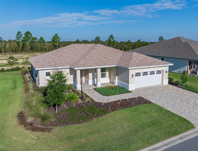 ranch-style house with a garage, covered porch, and a front yard