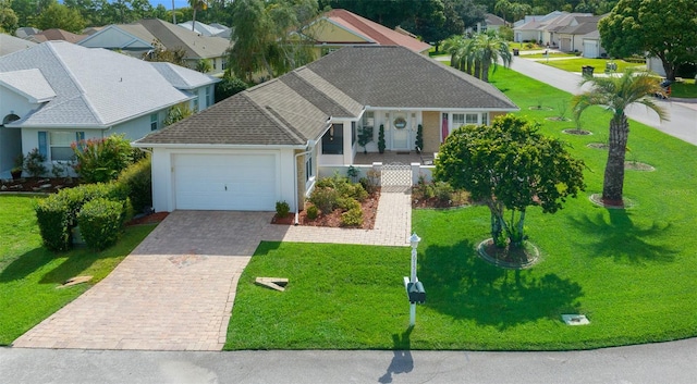 view of front of property with a garage and a front yard