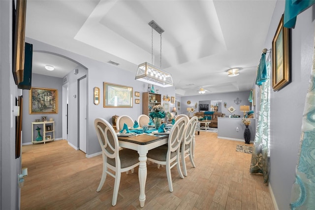 dining space with light hardwood / wood-style flooring and ceiling fan