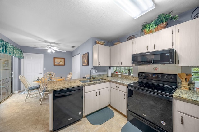 kitchen with sink, kitchen peninsula, black appliances, light stone countertops, and ceiling fan