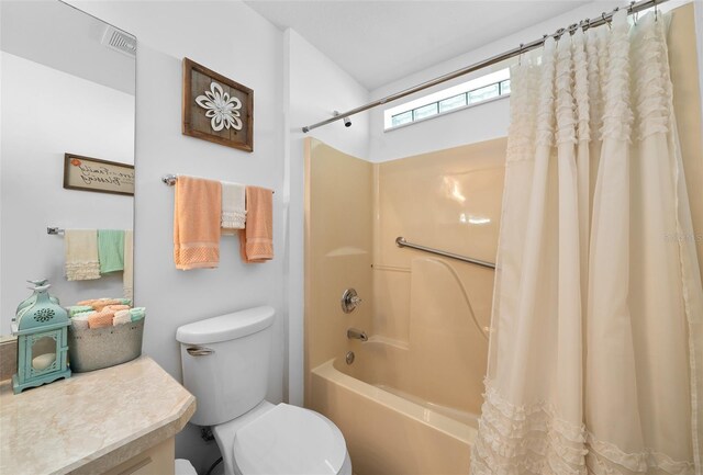 full bathroom featuring shower / bath combo, vanity, and toilet