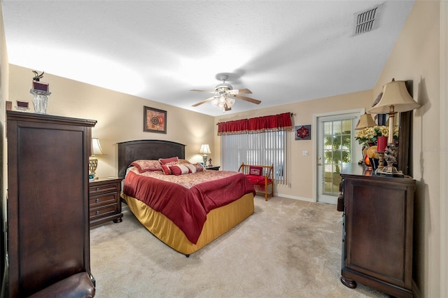 bedroom featuring access to outside, light colored carpet, a textured ceiling, and ceiling fan