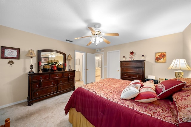 carpeted bedroom featuring ensuite bath and ceiling fan