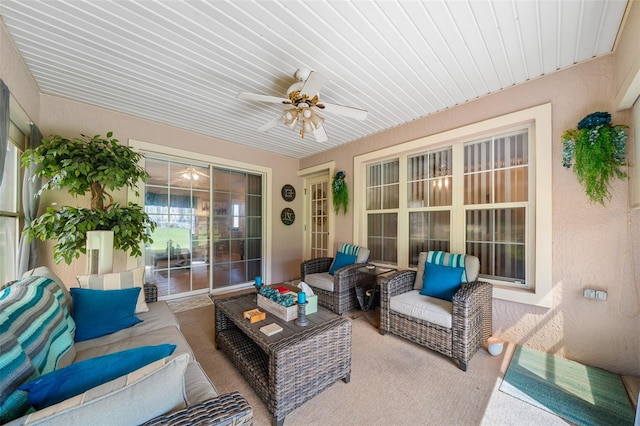 sunroom / solarium featuring ceiling fan