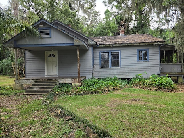 view of front of home with a porch and a front yard