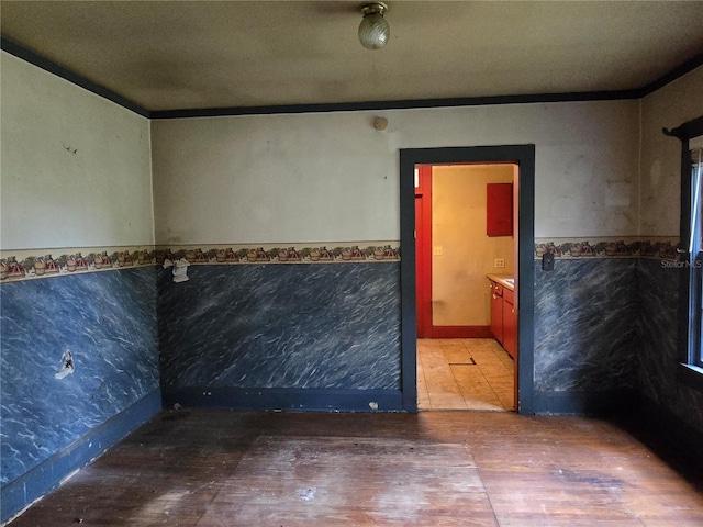 spare room with a textured ceiling, ornamental molding, and hardwood / wood-style flooring