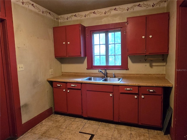 kitchen featuring light tile patterned flooring and sink