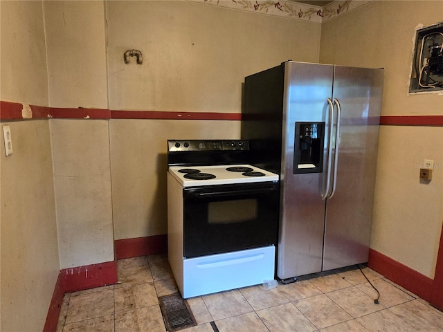 kitchen with stainless steel fridge and white range with electric stovetop