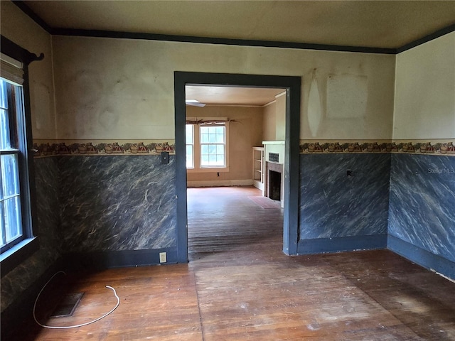 interior space with wood-type flooring and crown molding