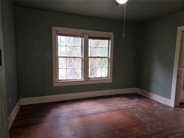 unfurnished room featuring dark hardwood / wood-style floors and ceiling fan