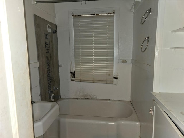 bathroom featuring vanity and  shower combination