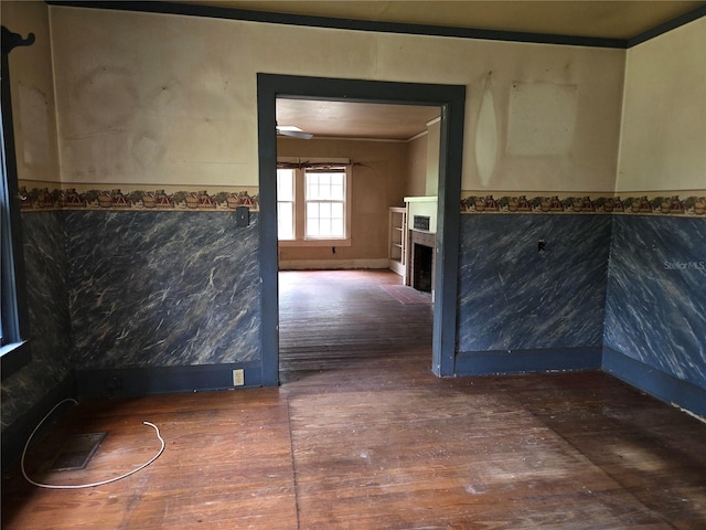 hall with ornamental molding and dark hardwood / wood-style floors