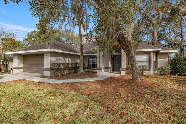 single story home featuring a garage and a front lawn