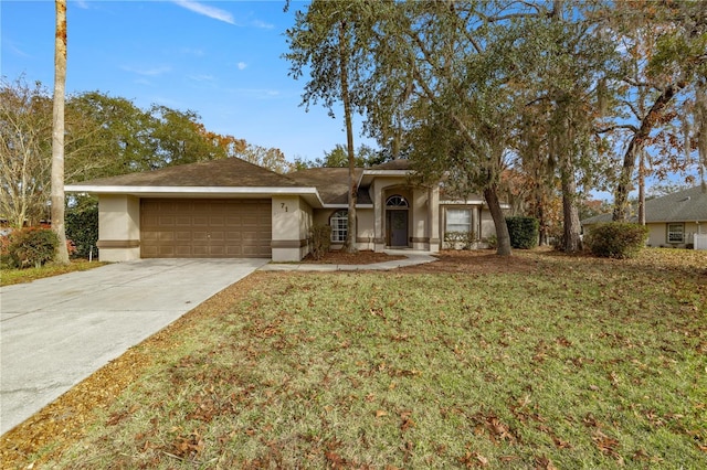 single story home with a garage and a front lawn