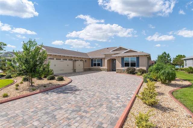 8445 SW 93rd Cir, Ocala, FL 34481 - single story home with an attached garage, stone siding, decorative driveway, and stucco siding
