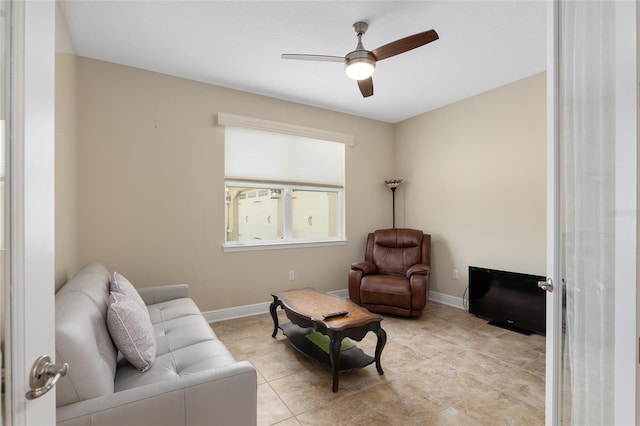 living area featuring ceiling fan and light tile patterned floors