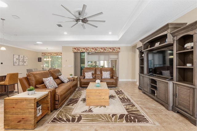 tiled living room with ceiling fan with notable chandelier and ornamental molding