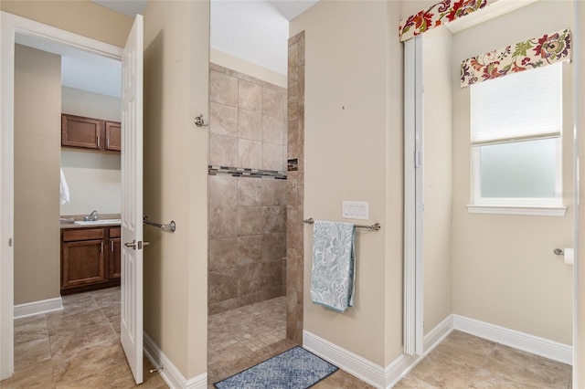 bathroom featuring vanity and tiled shower