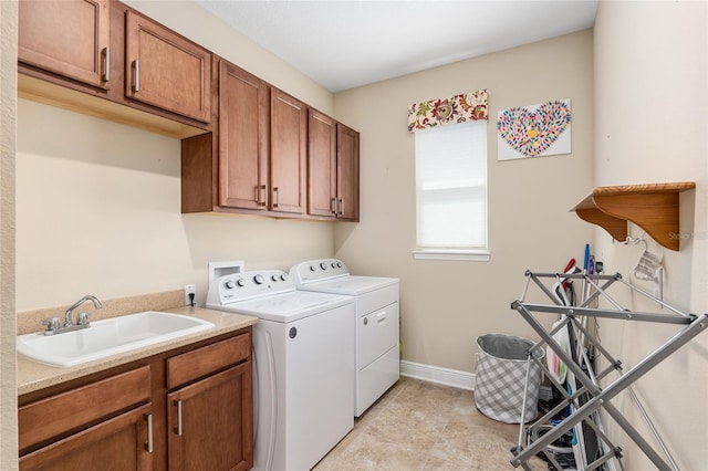 washroom featuring cabinets, washer and dryer, and sink