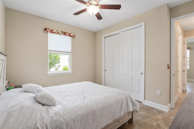 tiled bedroom featuring ceiling fan and a closet